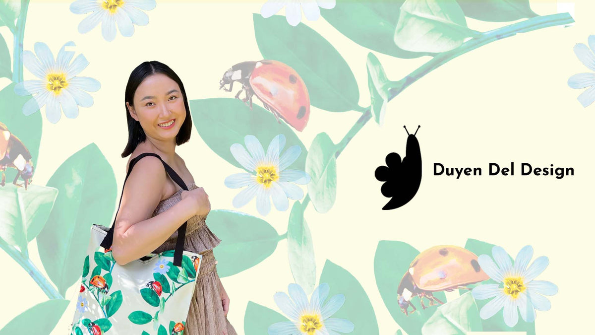  In the hero banner, Duyen is pictured holding her signature tote bag on her shoulder. A ladybug, flower and leaf pattern, is featured on the tote and in the banner's background. Her logo is also displayed in the hero banner. 